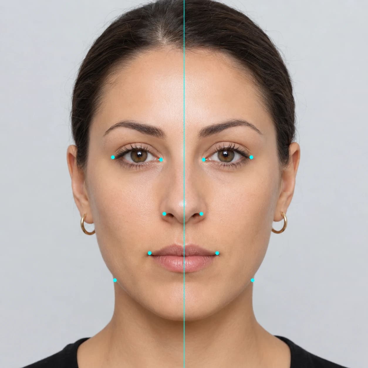 Face symmetry test example showing a vertical midline and paired landmark dots on a woman's face